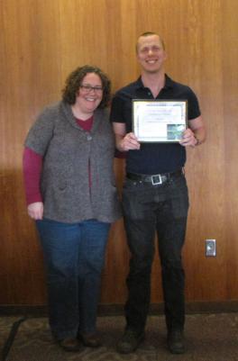 L to R: Jennifer Schlueter presents the Graduate Excellence in Service & Creative Activity Award to Max Glenn.