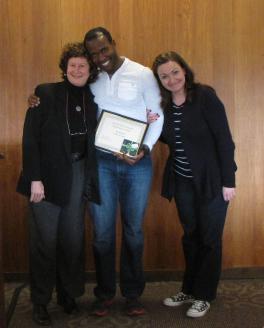 Jeanine Thompson (left), Mandy Fox (right) present Sifiso Mazibuko (center) the Graduate Excellence in Teaching Award. 