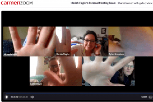 Zoom capture of 5 individuals reaching towards the camera with their hands