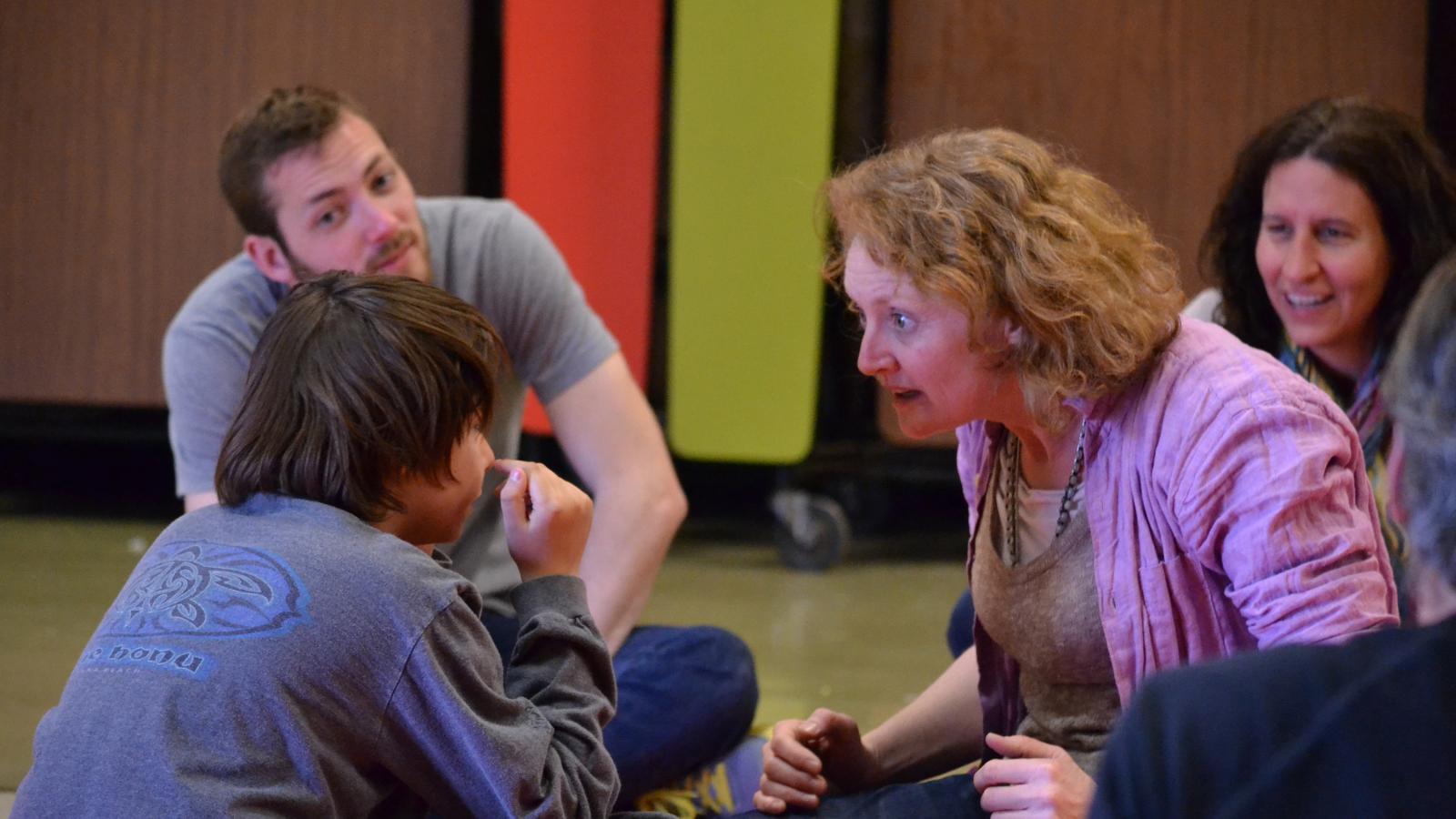 Guest artist Kelly Hunter works with a child during a workshop.