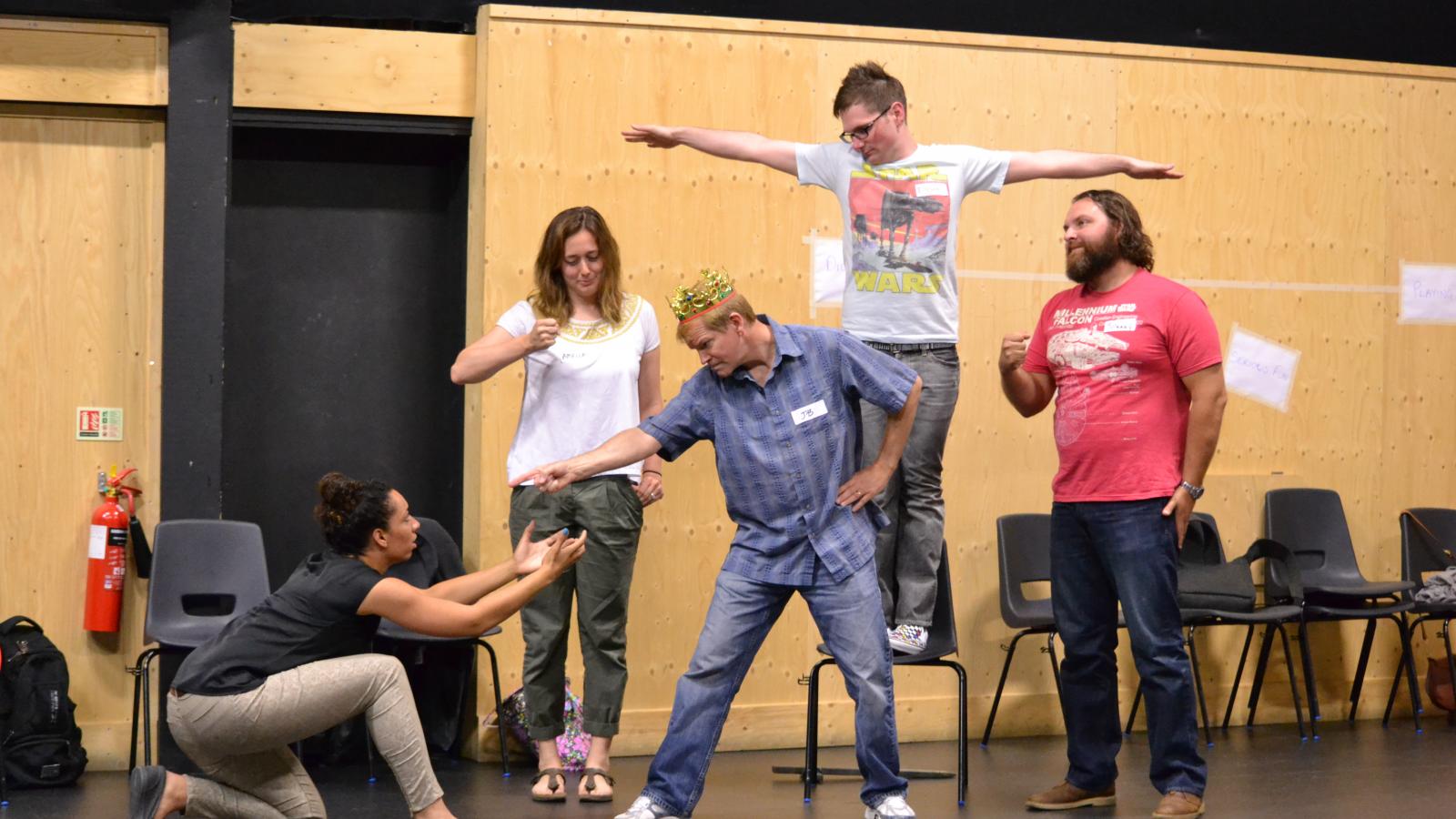 RSC Stand Up for Shakespeare training participants are creating a tableau from Henry IV, Part II.  Left to right: Kayla Jackmon, Amelia Baumgardner, JB Jagerman, Elliot Lemberg, and Johnny Merry-June, 2014, The Clore Learning Center in Stratford-upon-Avon